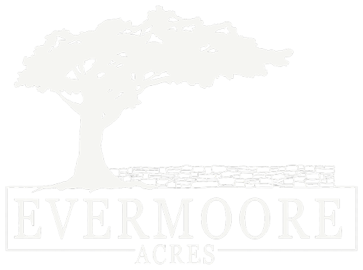 The Evermoore Acres stacked logo: a broad tree above a dry-stacked stone wall, with the wordmark set in a ruled box beneath